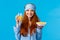 Health, food and diet concept. Pretty glamour foxy teenage girl in sleepwear, sleep mask, holding cereals and orange
