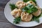 Health food. Vegetarian pumpkin mantas on a white plate, decorated with herbs.