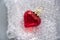 Health, heart, medicine, love, emotion, plastic. Decorative red glass heart on the plastic pack. Concept of glass love. Concept of