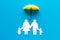 Health insurance concept. Family cutout under umbrella on blue background top-down copy space