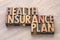 Health insurance plan word abstract in wood type