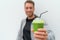 Health man drinking weight loss green smoothie drink. Hand holding plastic cup of vegetable juice, healthy food diet