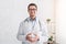 Health and medical blog. Smiling male doctor in white coat and glasses