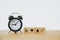 Health and medical icon on wooden block and  black analog alarm clock on wood desk for health insurance, nonstop medical service