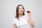 Health, people, food and beauty concept - Lovely smiling teenage girl eating chocolate on white background