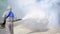 health personal worker using fogging machine spraying chemical to eliminate mosquitoes and prevent dengue fever
