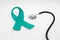 Health protection concept, ovarian cancer, stethoscope and turquoise ribbon