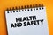 Health And Safety text on notepad, medical concept background