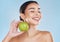 Health, skincare and beauty woman with an apple for wellness, healthy and organic lifestyle in studio. Girl with clear