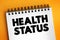 Health Status - individual`s relative level of wellness and illness, text concept on notepad