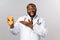 Healthcare, healthy diet and disease concept. Happy cheerful african-american bearded doctor, physician explain pros of