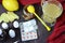 Healthcare, traditional medicine and flu concept - tea cup with lemon, ginger, honey and pills on wooden table. tablets