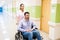 Healthcare Worker Assisting Patient On Wheelchair