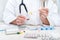 Healthcare worker makes a daily tray of pills for a patient