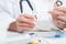 Healthcare worker makes a daily tray of pills for a patient