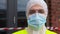 Healthcare worker in protective gear outdoors