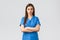 Healthcare workers, prevent virus, insurance and medicine concept. Serious and confident female nurse in blue scrubs