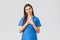 Healthcare workers, prevent virus, insurance and medicine concept. Touched and flattered female nurse or doctor in blue