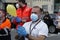 Healthcare workers wearing facemasks facing coronavirus crisis applaud