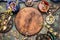 Healthful herbs tea setting around round wooden board on rustic background, top view