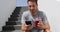 Healthy active lifestyle man using smart mobile phone app while drinking red smoothie holding cellphone on jogging break