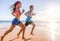 Healthy active runners couple running on beach working out cardio together. Fitness sports lifestyle