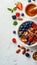 Healthy american breakfast with cornflakes, berries, and honey on white background