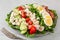 Healthy American Cobb salad with egg bacon avocado chicken tomato. hearty keto low carb diet