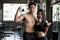 Healthy Asian couple in fitness gym