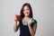 Healthy Asian woman with dumbbell and tomato juice.