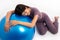 Healthy Asian woman Rest over by lying on the ball after a workout with fitball on isolated white background, Concept of good