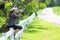 Healthy athletic asian woman is drinking pure water from the bottle refreshing herself after exercise in the nature park