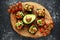 Healthy Avocado and cherry tomato rye sourdough toasts with pumpkin, sesame and nigella seeds, drizzled with olive oil