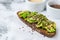 Healthy avocado toast on concrete background. Wholegrain bread, sesame flax seeds. Vegan keto diet. Healthy eating. Trendy