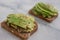 Healthy avocado toast. Mashed avocado on whole grain rye bread