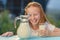 Healthy baby milk - Portrait beautiful redhead girl drinking fresh milk outdoors.