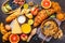 Healthy balanced breakfast on a dark background. Muesli, milk, juice, croissants, cheese, biscuits