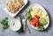 Healthy balanced breakfast or snack - smoked salmon, egg salad and avocado. On a gray background, top view. Healthy food