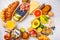 Healthy balanced breakfast on white background. Muesli, juice, croissants, cheese, biscuits and fruit, top view