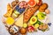 Healthy balanced breakfast on white background. Muesli, juice, croissants, cheese, biscuits and fruit, top view