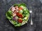 Healthy balanced diet food - canned tuna, tomatoes, cucumbers, romaine salad, red onion, olive oil salad dressing appetizer, lunch
