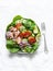 Healthy balanced  food - canned tuna, tomatoes, cucumbers, lettuce, red onion, olive oil salad for appetizer, lunch, tapas  on a