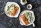 Healthy balanced lunch - creamy spinach orzotto and teriyaki tray bake salmon on a dark background, top view
