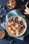 Healthy banana smoothie bowl with blueberry chocolate walnuts