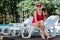 Healthy beaming retired woman wearing straw hat getting suntan