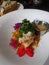 Healthy beautiful dinner of Triple Tail Fish and Sweet Potato Hash decorated with flowers