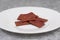 Healthy beetroot crackers in white bowl. cookies from beets on white background