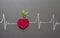 Healthy beetroot with heart shape and electrocardiogram on blackboard