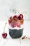 Healthy Black Forest dessert. Black activated charcoal chia pudding with cherries, coconut cream and chocolate. Vegan breakfast