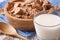 Healthy bran flakes in a wooden bowl and milk close-up. horizontal